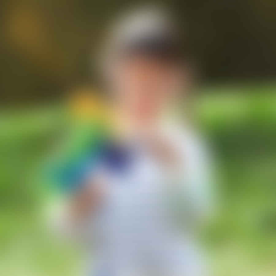 Child holding a small size Nerf gun, ready for battle